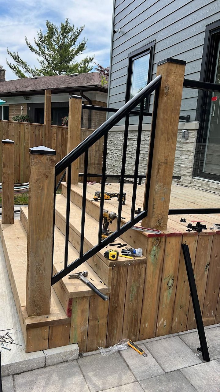 Custom deck stairs with metal railing installation in Toronto