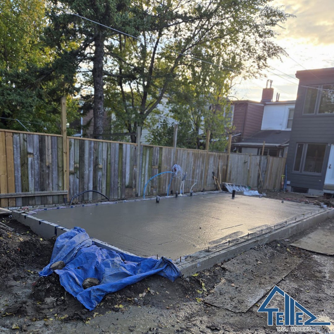 Freshly poured concrete foundation slab for home addition in Toronto