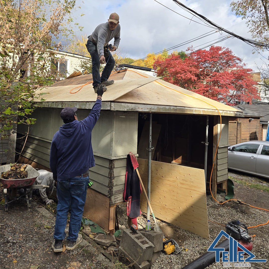 Crew installing new plywood roof sheathing on garage restoration in Toronto