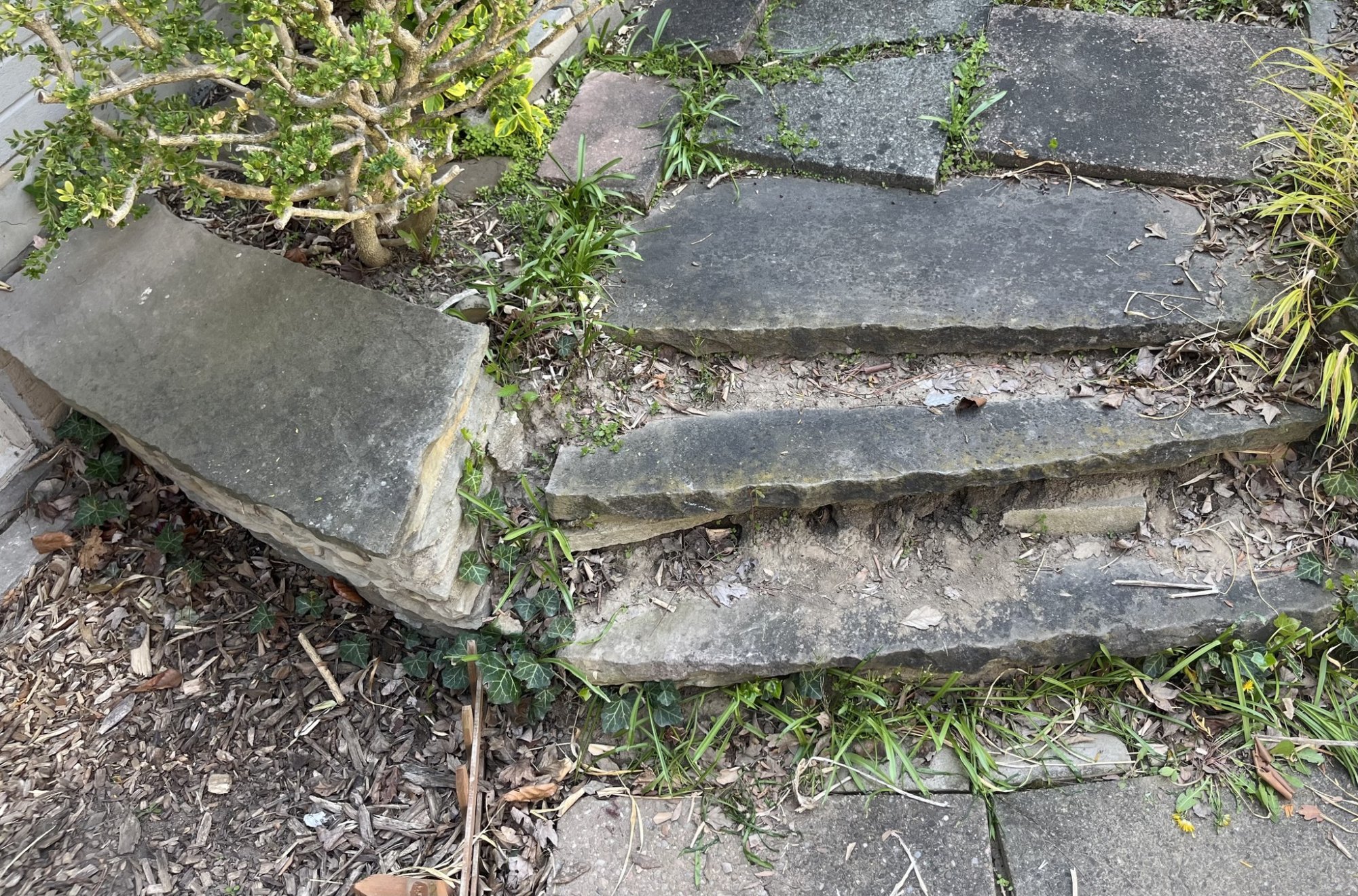 Deteriorating stone steps and retaining wall before repair in Toronto